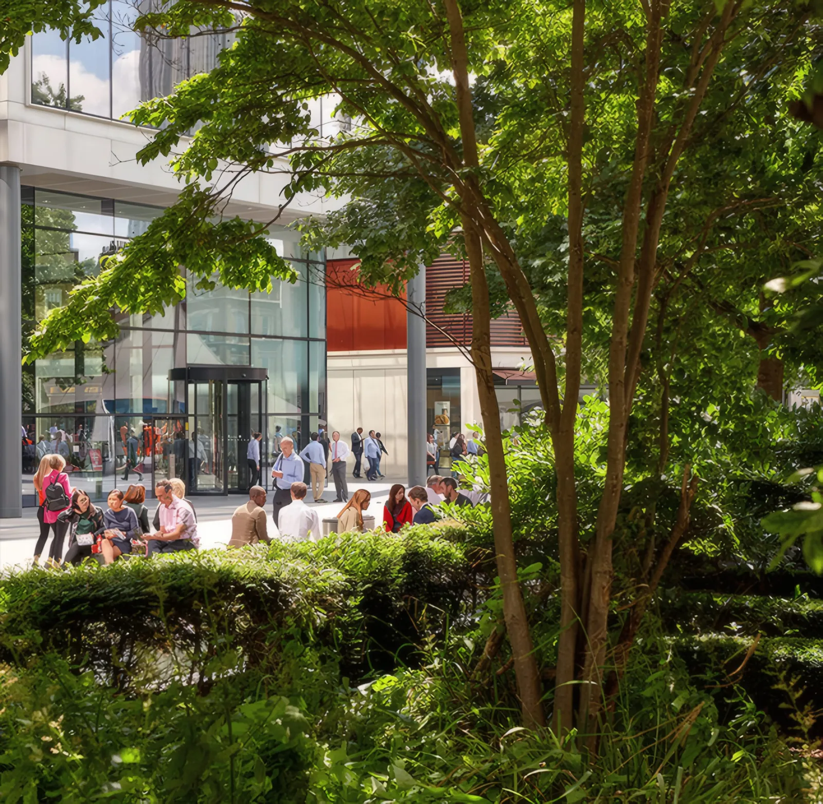 The main entrance and revolving doors, seen through the landscaping.