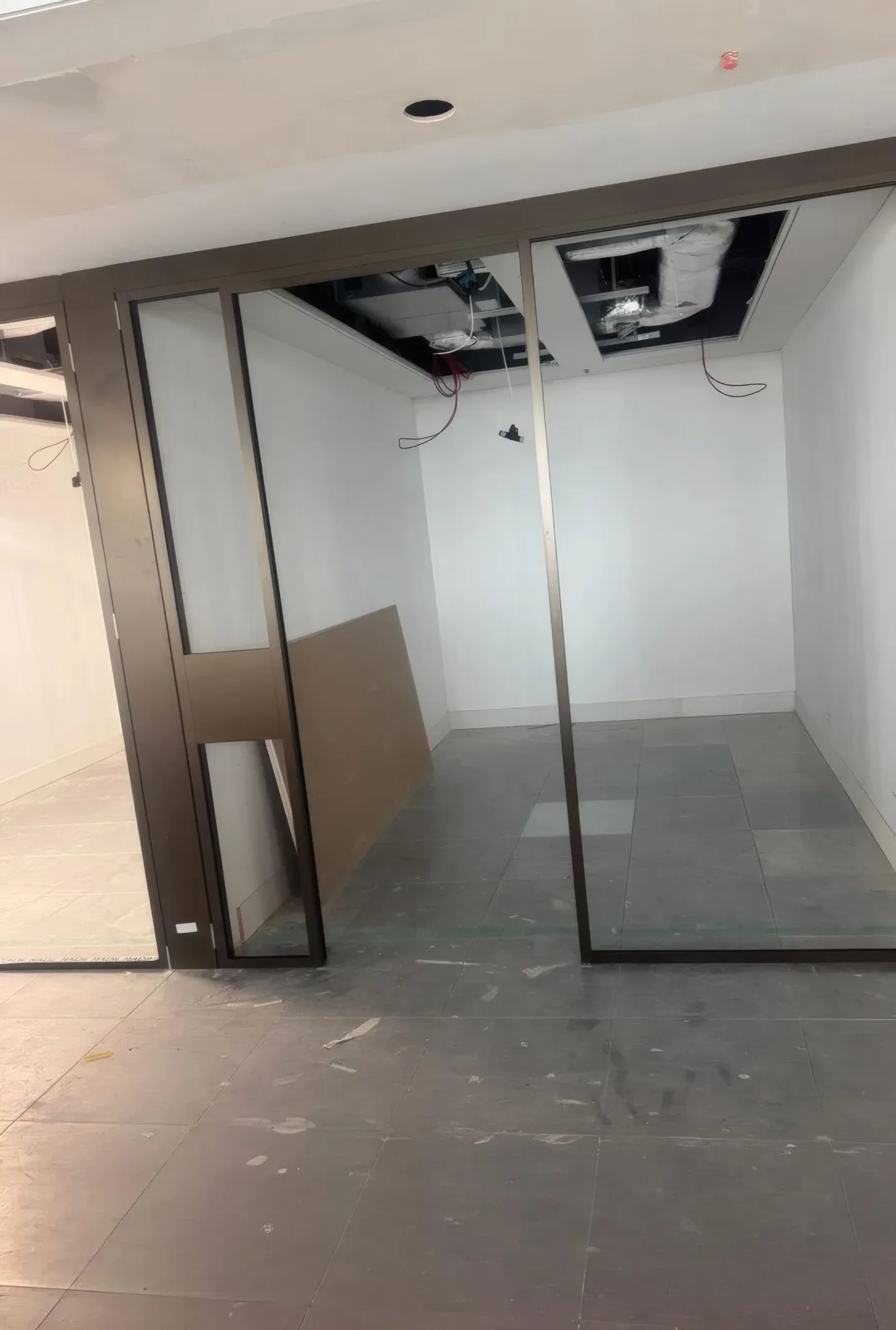 Glazed office partition framing installed and set out, ready for final fit-out.