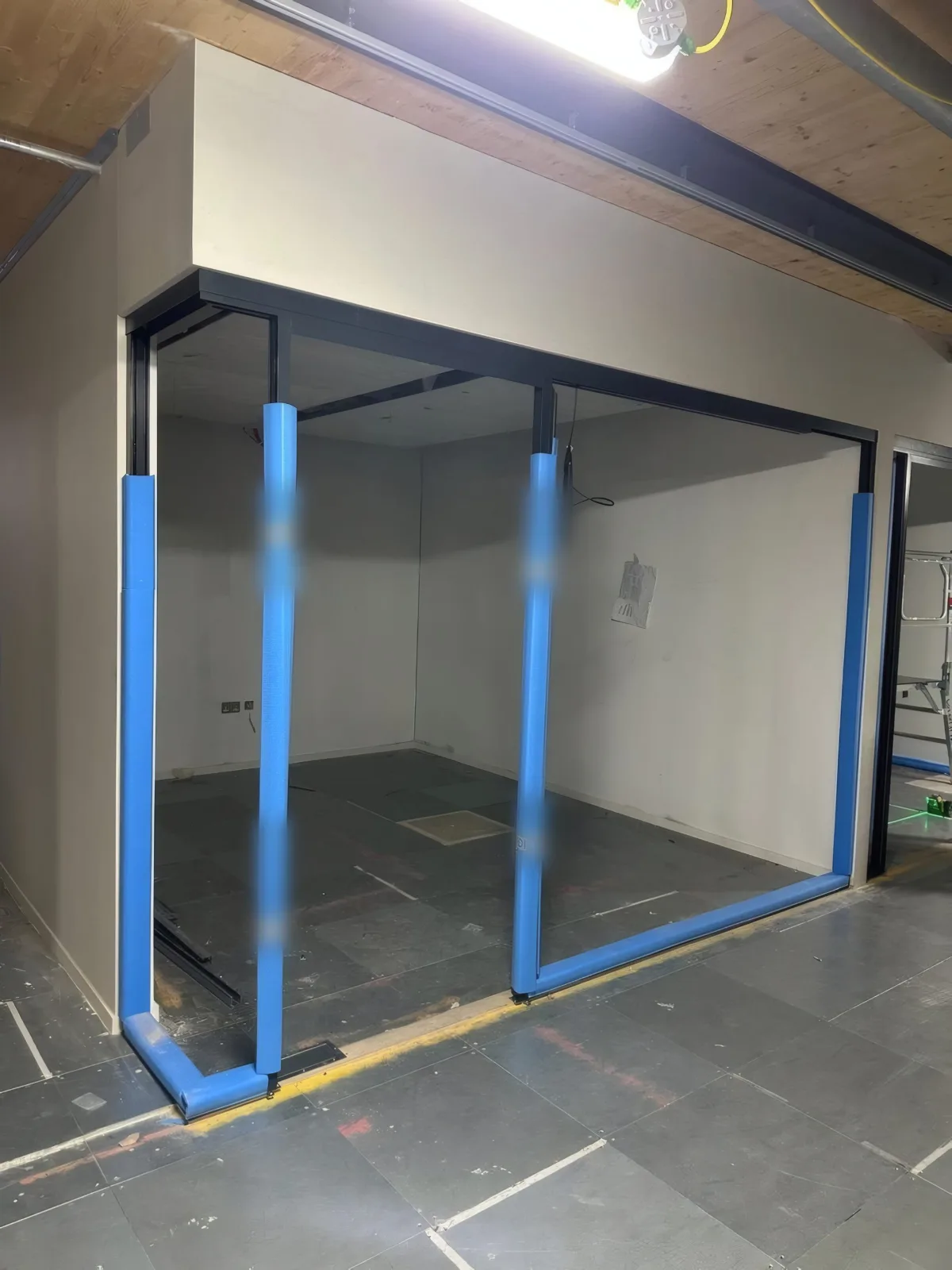 Partition framing with protective edge guards in place during the installation stage.