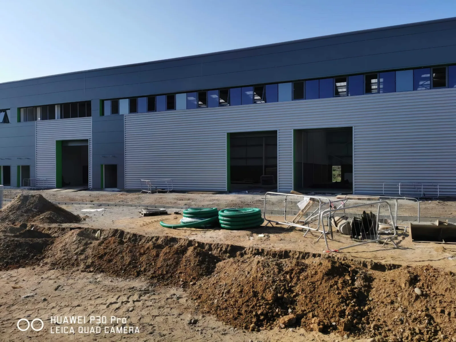 Cladding and loading doors to a unit, with groundworks in front.