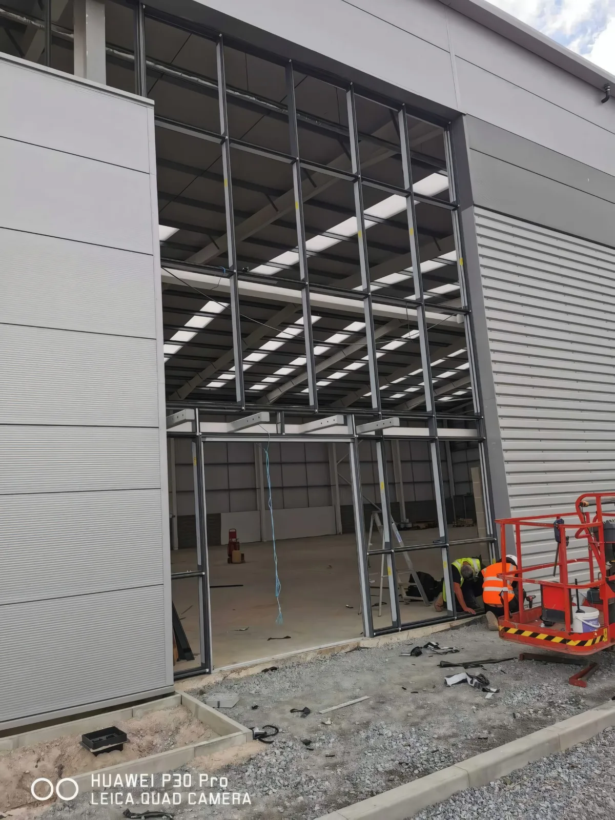Glazed framing to a unit entrance, with an access platform at its base.