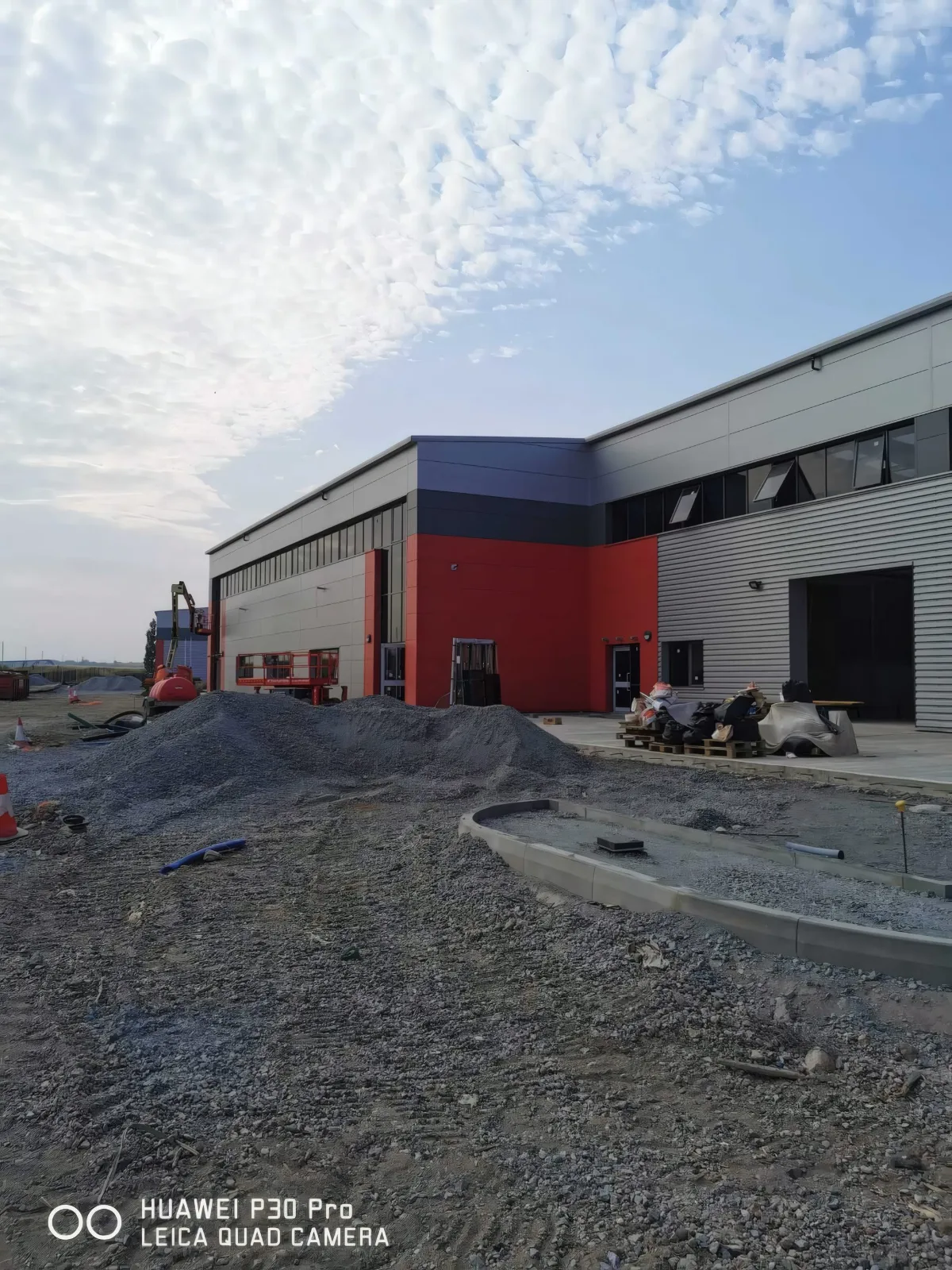 A completed unit with red and grey cladding.