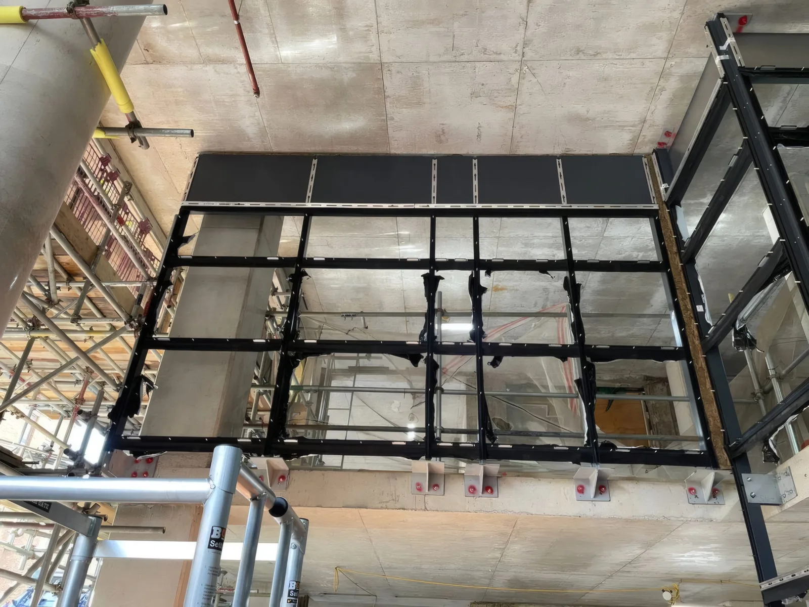 Structural steelwork for the curtain wall grid, erected floor by floor ahead of glazing.
