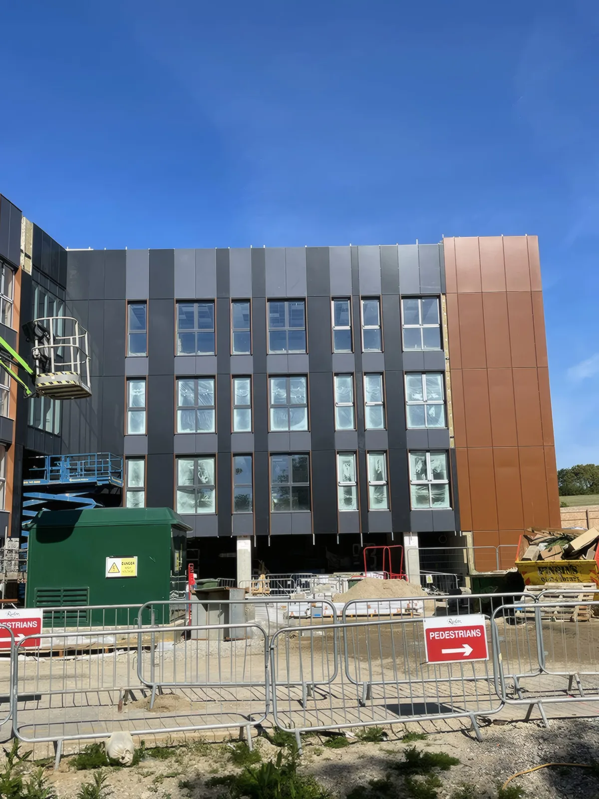 The main elevation behind the site hoarding.