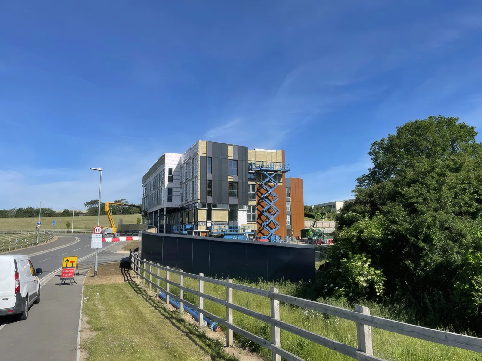 The building from the approach road, with the cladding nearly complete.