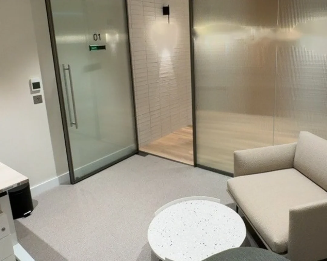 Consultation room: a framed glazed door and reeded screen.