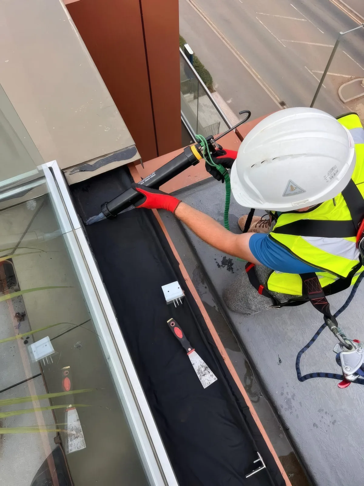 Sealant being applied to a membrane joint as part of the balcony weatherproofing detail.