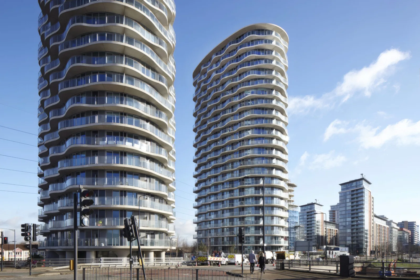 The two curved residential towers from street level.