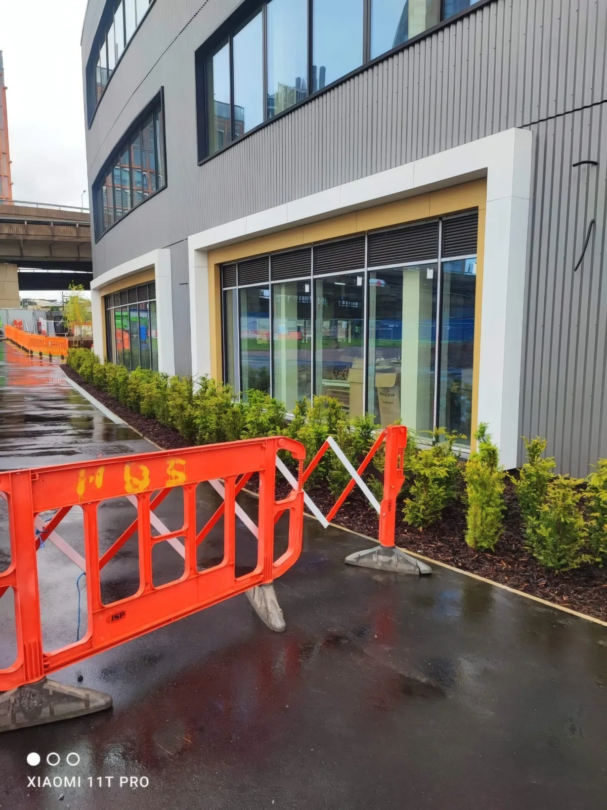 Ground-floor glazing and new planting beside the building.